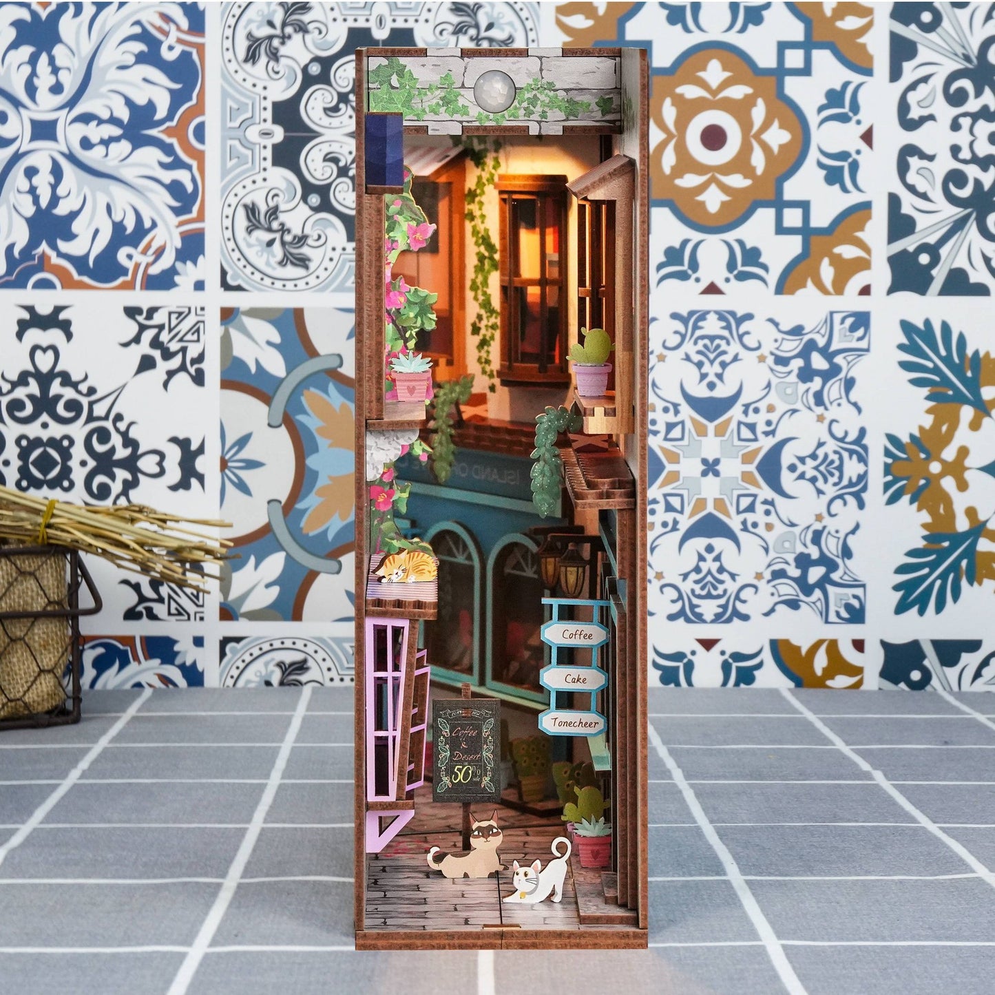 Miniature dollhouse with decorative elements on a patterned floor