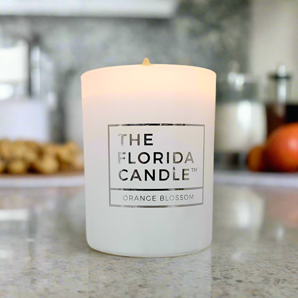 White candle labeled 'The Florida Candle' with 'Orange Blossom' on a white background