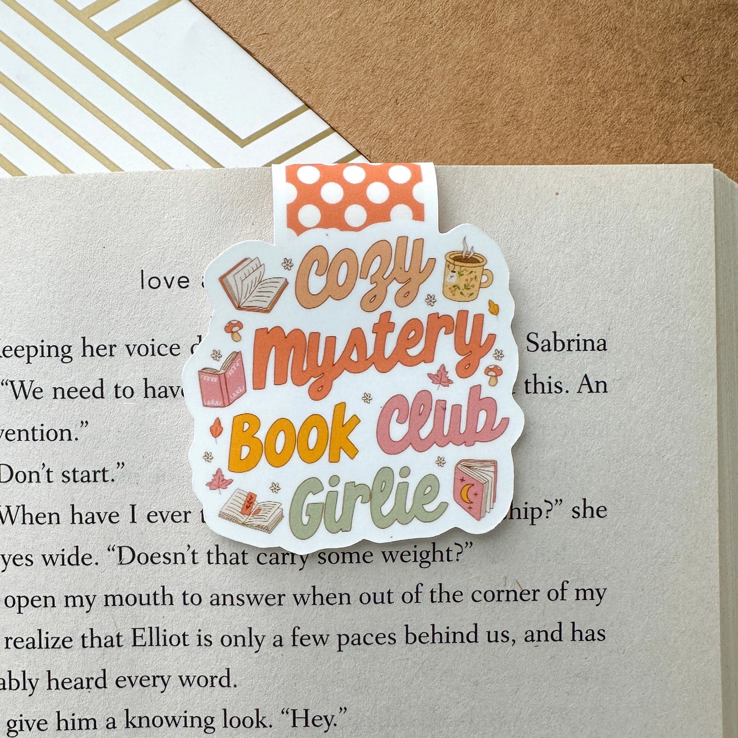 Book club-themed bookmark on a book page with text
