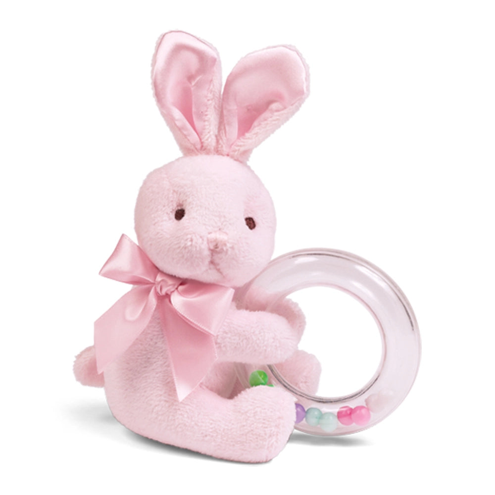 Pink plush bunny with a teething ring on a white background