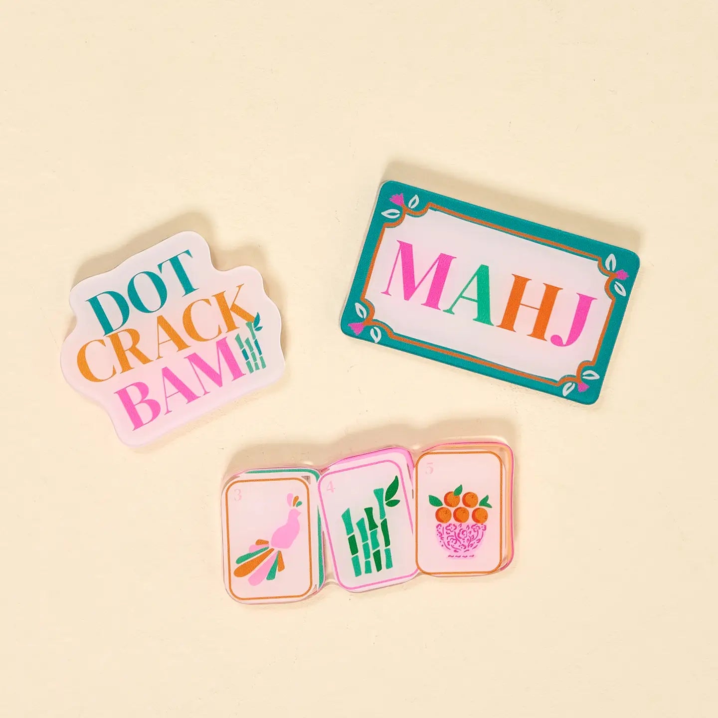 Set of colorful card games with 'Dot Crack Bam' and 'MAHJ' text on a beige background