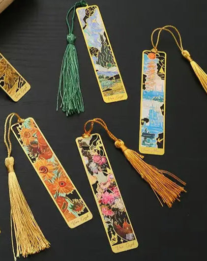 Decorative bookmarks with tassels on a dark surface
