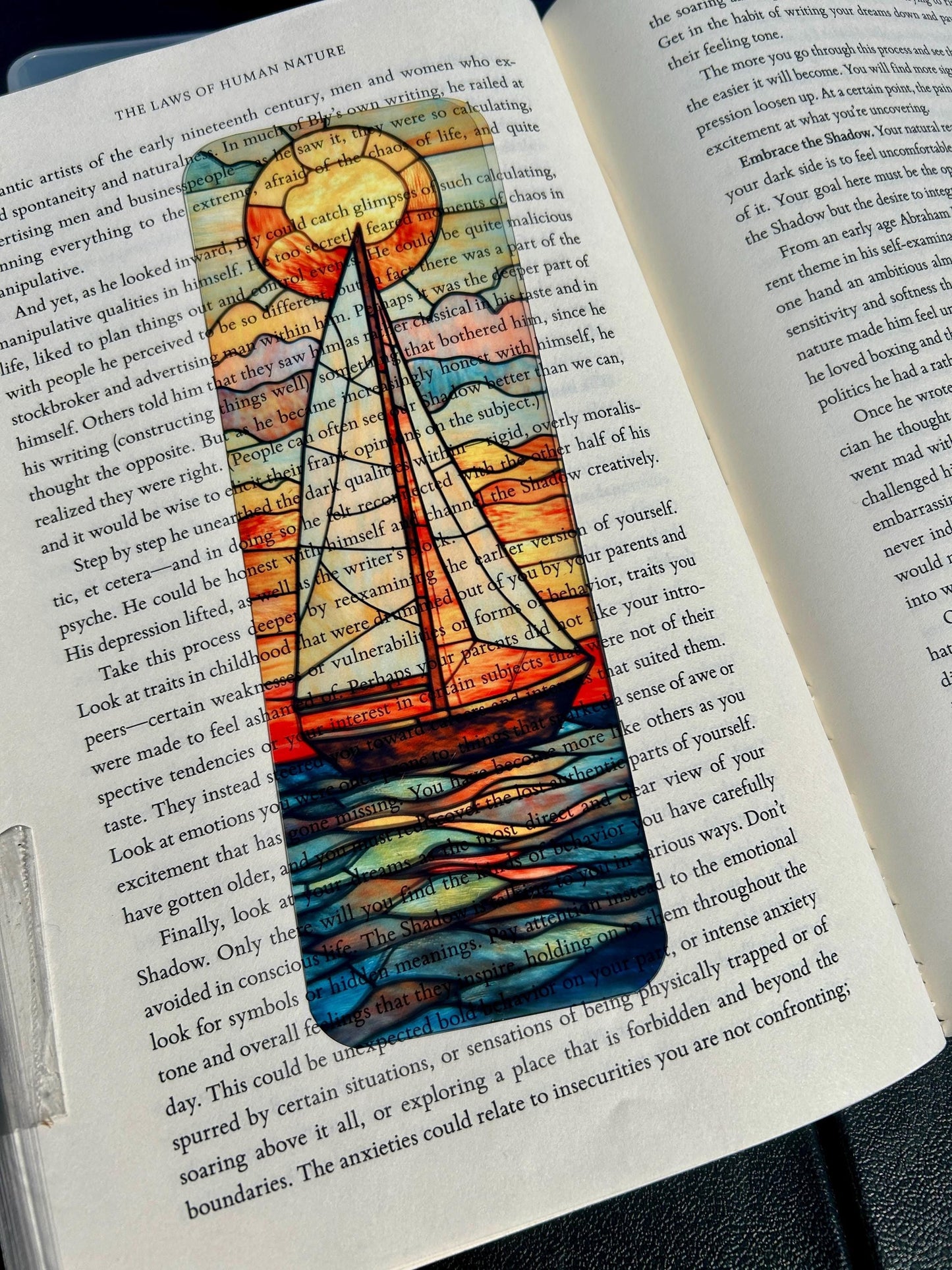 Sailboat at golden sunset bookmark in stained glass style, nautical ocean art with glowing orange and blue waves
