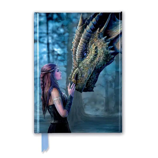 Notebook with a dragon and a woman on the cover in a forest setting