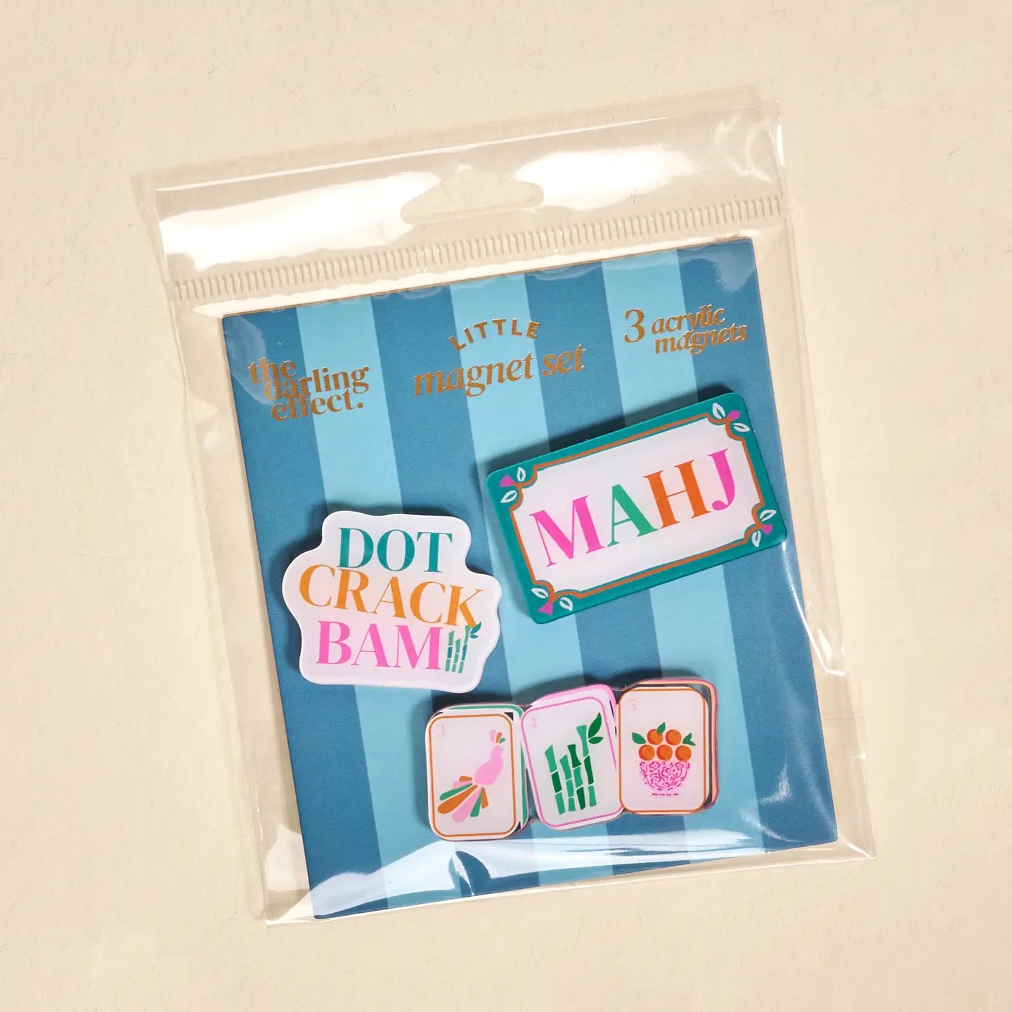 Packaged set of colorful magnetic pins with text and graphics on a striped background.