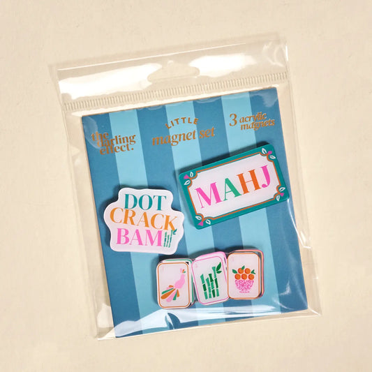 Packaged set of colorful magnetic pins with text and graphics on a striped background.