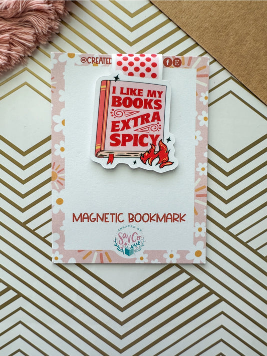 Magnetic bookmark with 'I Like My Books Extra Spicy' design on a decorative card.