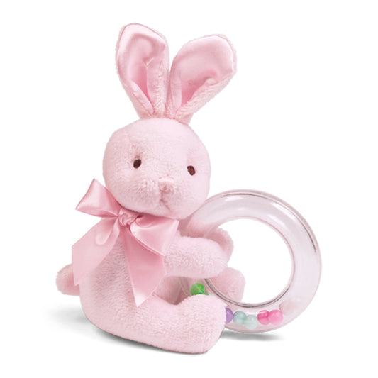 Pink plush bunny with a teething ring on a white background
