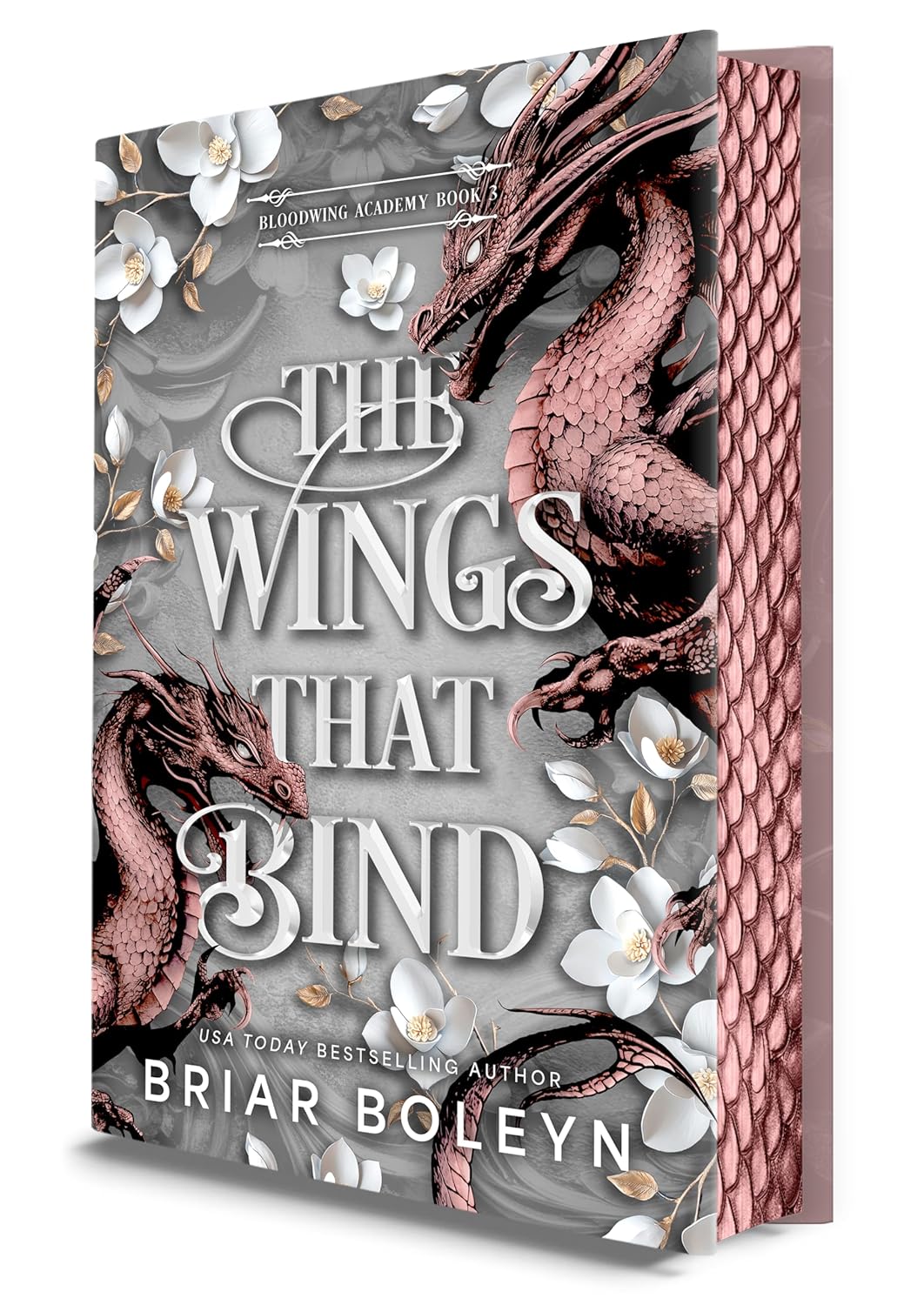 Book cover of 'The Wings That Bind' with dragons and floral design
