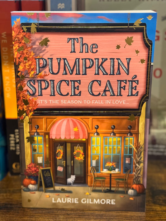 Book titled 'The Pumpkin Spice Cafe' by Laurie Gilmore with a colorful cover featuring a cafe scene.