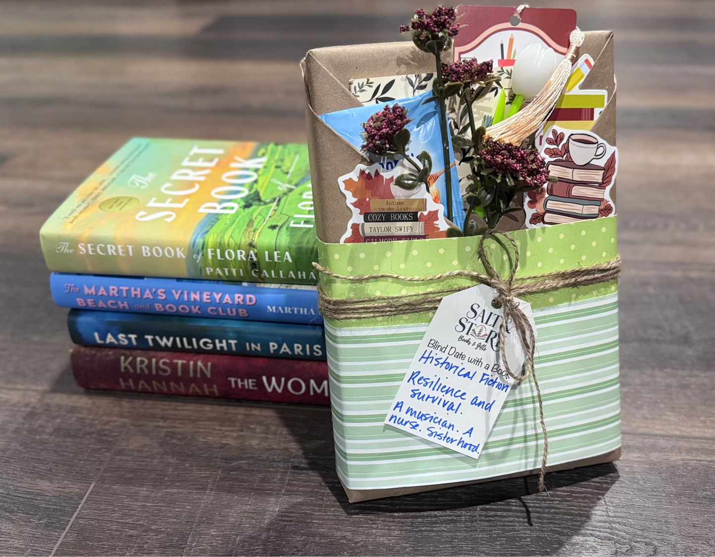 Stack of books with a decorative box on a wooden surface
