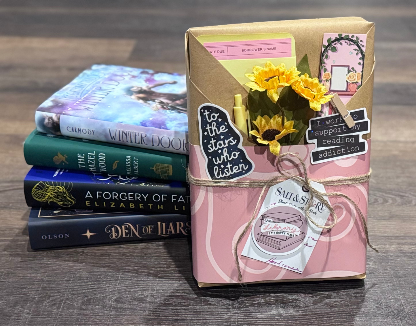 Stack of books with a wrapped gift on a wooden surface