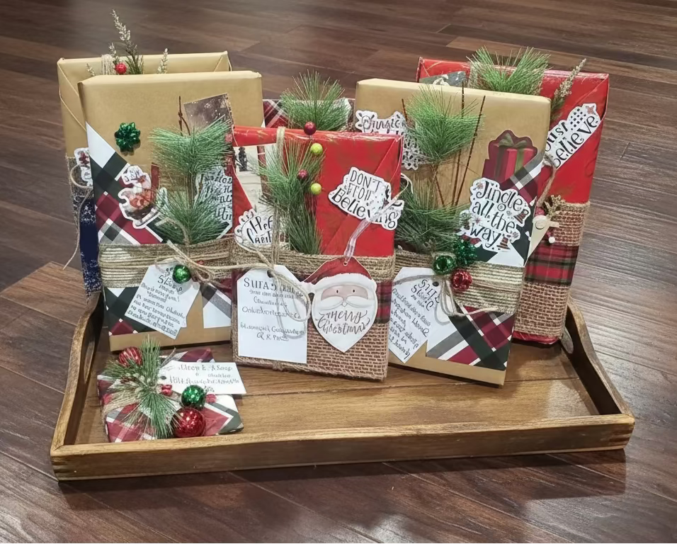 Collection of Christmas-themed gift bags and boxes on a wooden surface.