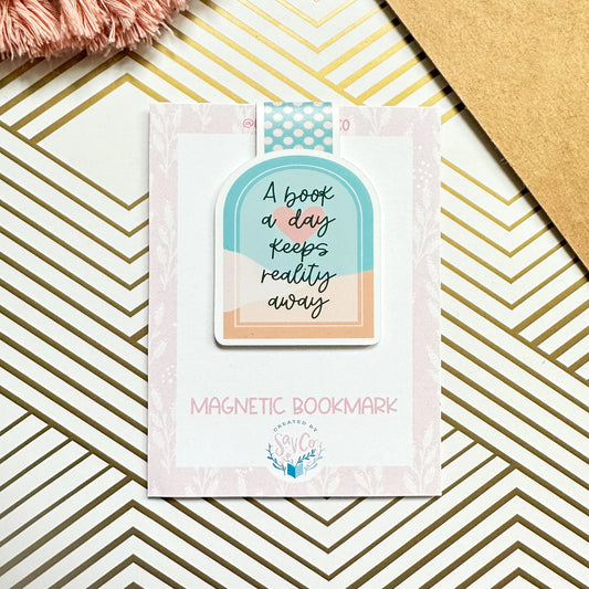 Magnetic bookmark with motivational quote on a decorative surface